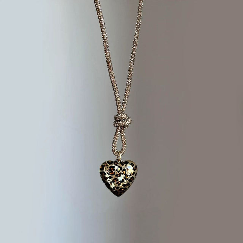 Woman wearing layered pearl necklaces.