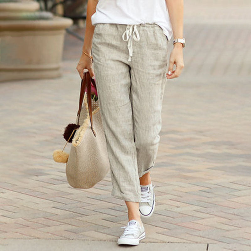 Woman wearing loose blue linen pants.